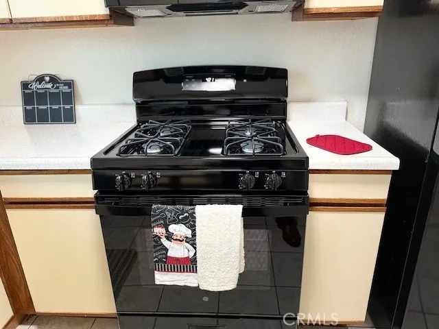 a stove top oven sitting inside of a kitchen