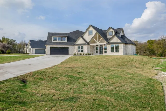 a view of a big house with a big yard and large trees