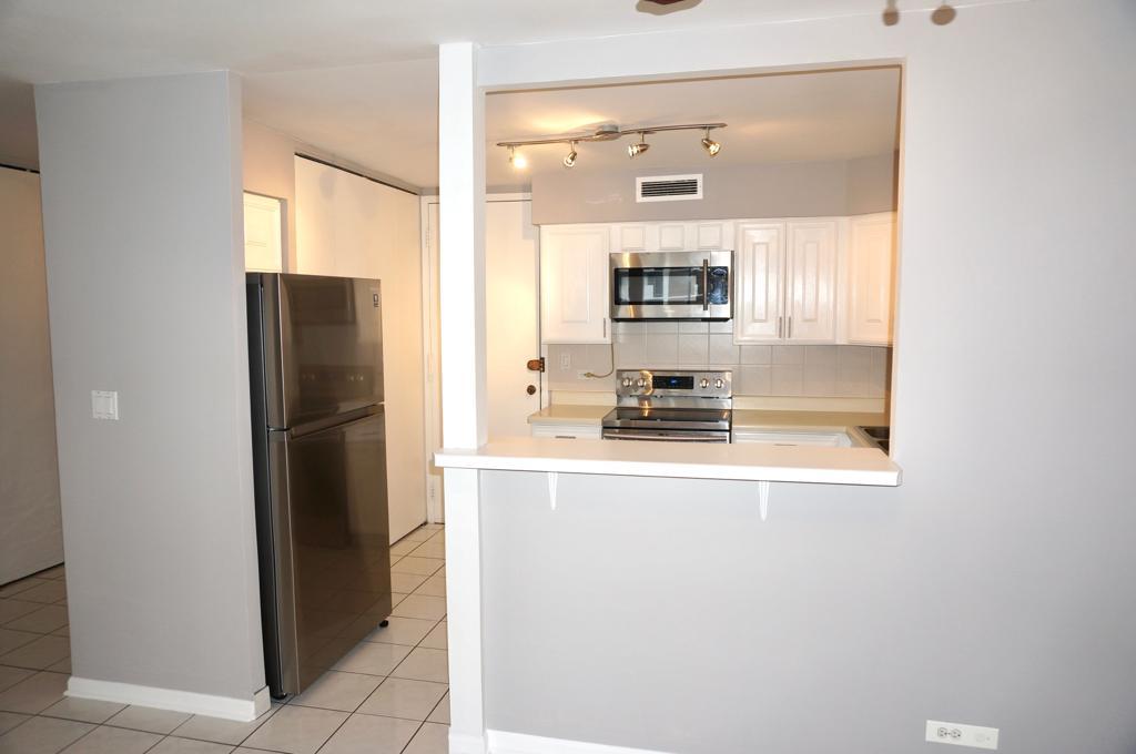 6007 North Sheridan Road, Unit 32D Chicago, IL 60660 - Photo 11 of 20 a kitchen with a refrigerator and a stove top oven