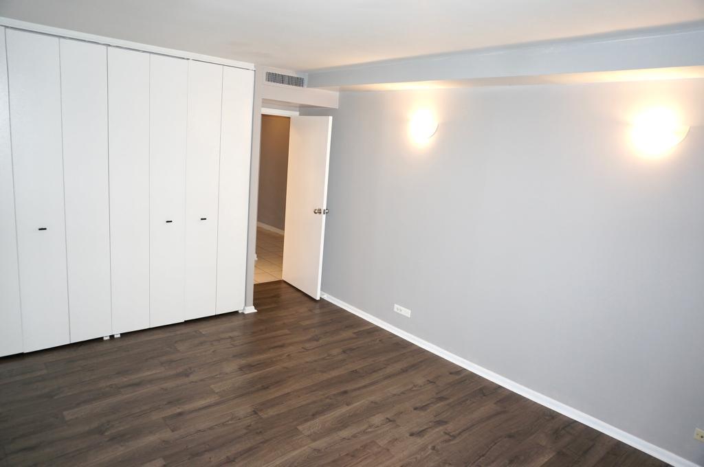 6007 North Sheridan Road, Unit 32D Chicago, IL 60660 - Photo 13 of 20 a view of an empty room with wooden floor