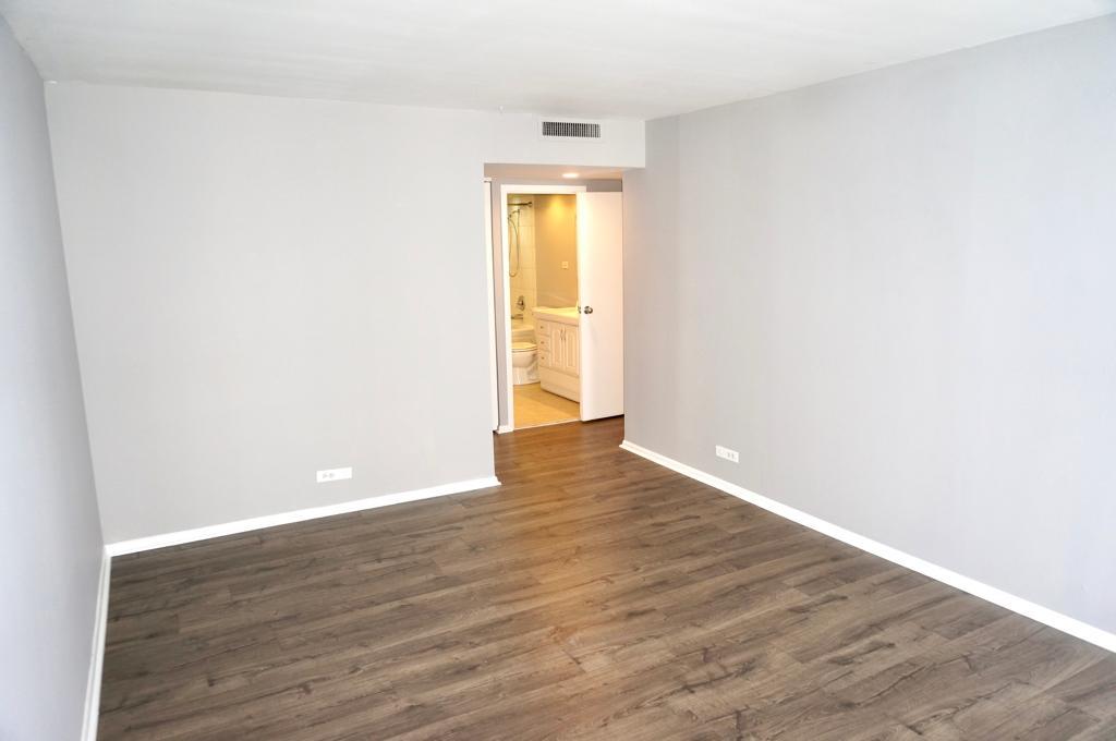 6007 North Sheridan Road, Unit 32D Chicago, IL 60660 - Photo 16 of 20 a view of an empty room with wooden floor and a window