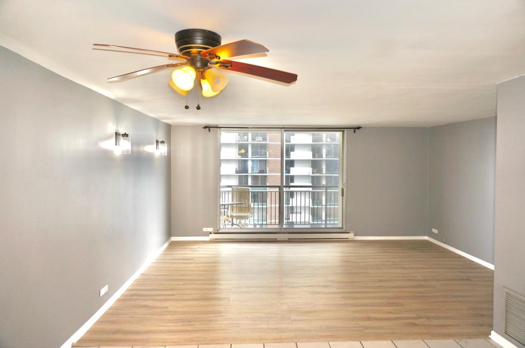 6007 North Sheridan Road, Unit 32D Chicago, IL 60660 - Photo 7 of 20 a view of an empty room with window and wooden floor