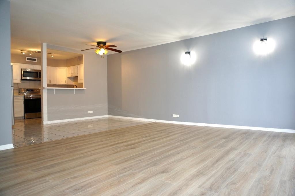 6007 North Sheridan Road, Unit 32D Chicago, IL 60660 - Photo 8 of 20 a view of an empty room with wooden floor and a ceiling fan