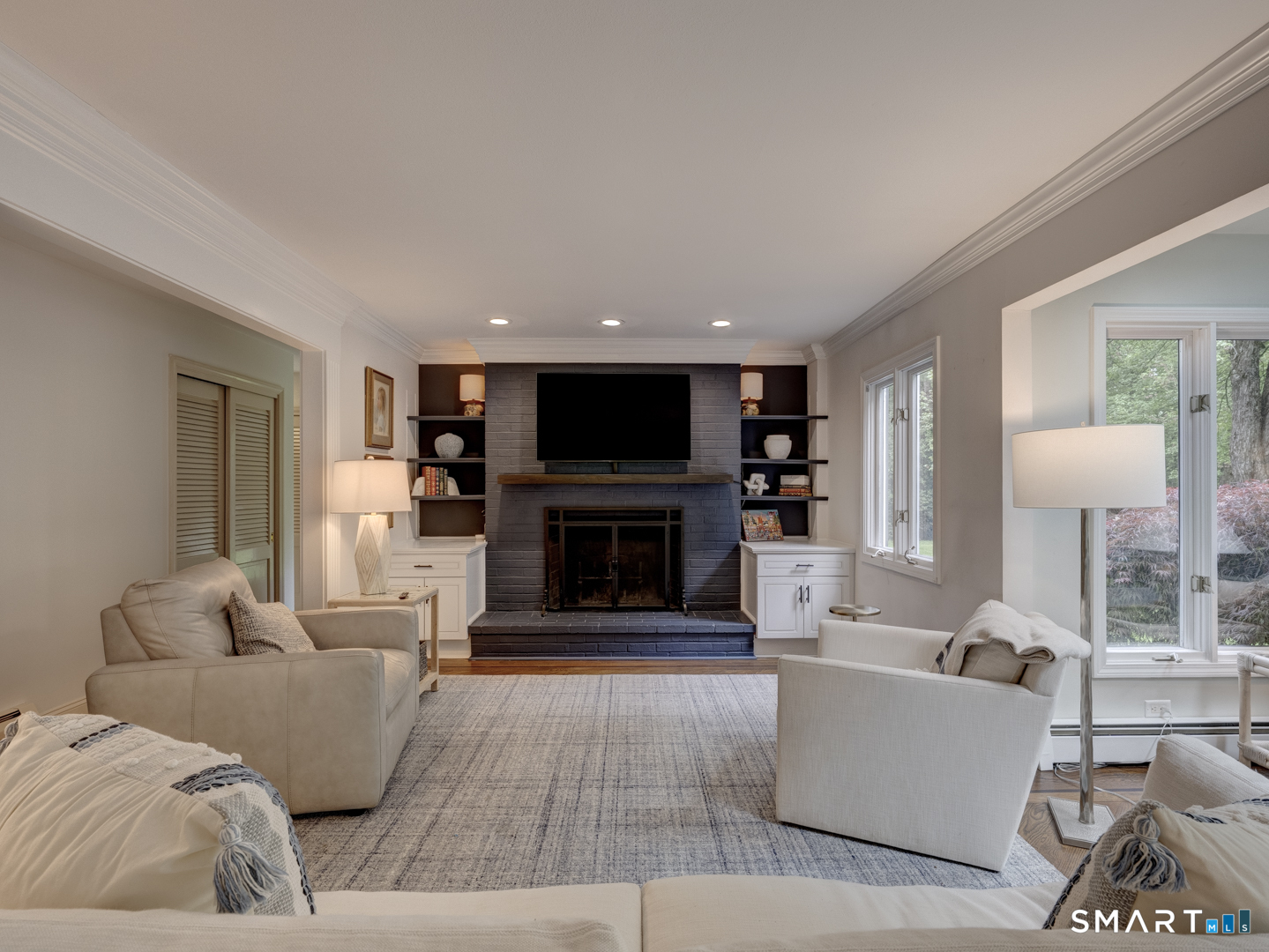 78 Windtree Street Torrington, CT 06790 - Photo 14 of 40 a living room with furniture a fireplace and a flat screen tv