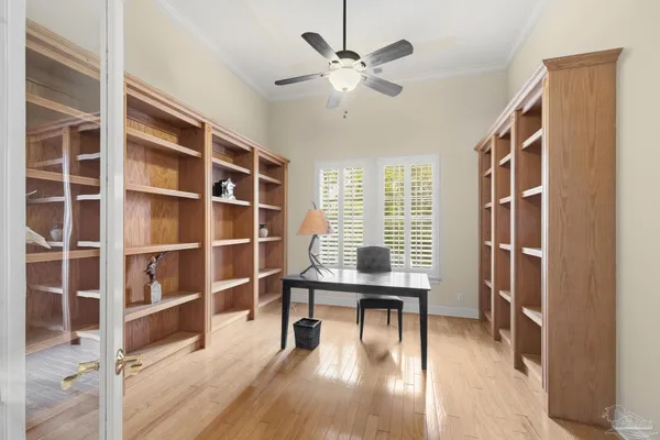 a living room with furniture large window and wooden floor