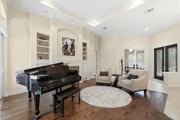 a kitchen with stainless steel appliances granite countertop a sink a refrigerator and a wooden floor