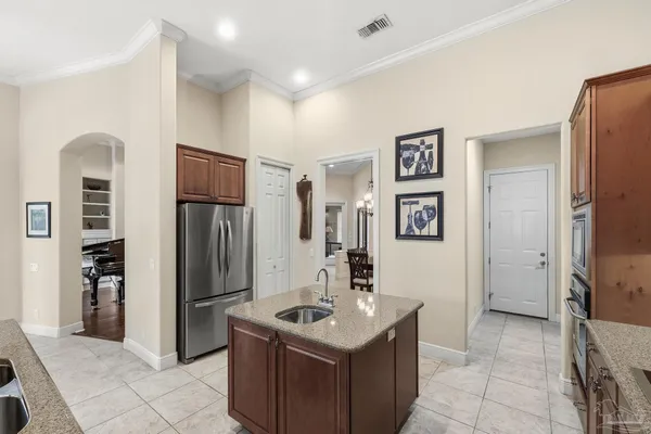 a kitchen with granite countertop a sink cabinets and stainless steel appliances