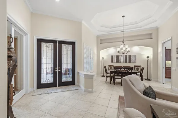 a view of a dining room with furniture and chandelier