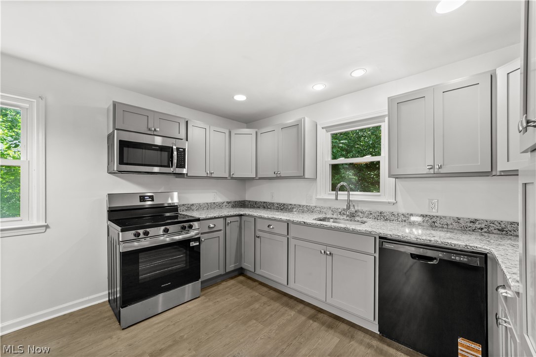 6444 Wilson Mills Road Cleveland, OH 44143 - Photo 5 of 29 Beautifully Updated Kitchen with New Cabinets, Counters, Stainless Steel Appliances, Flooring and Lighting