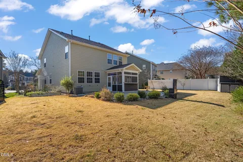 a view of house with yard and swimming pool