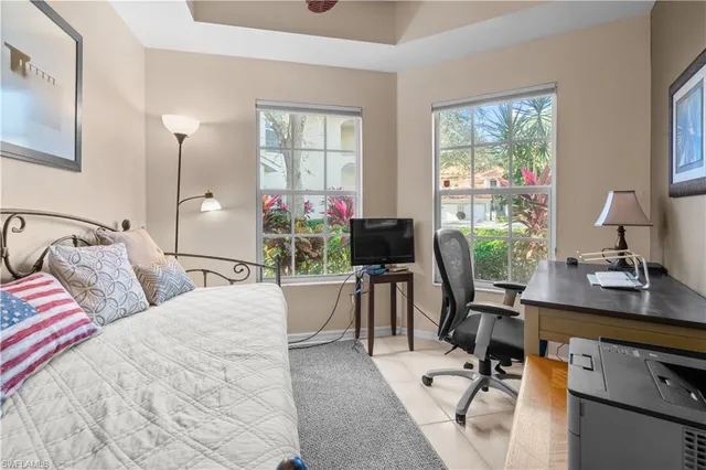 a bedroom with a bed and a desk