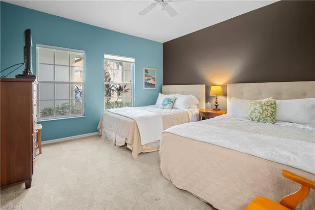 a spacious bedroom with two beds and a window