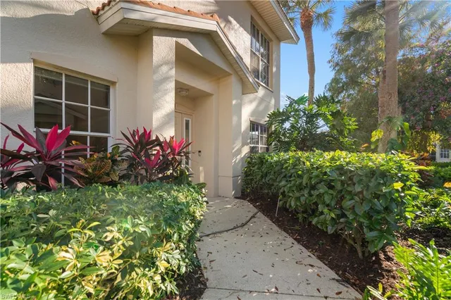 a view of a house with potted plants