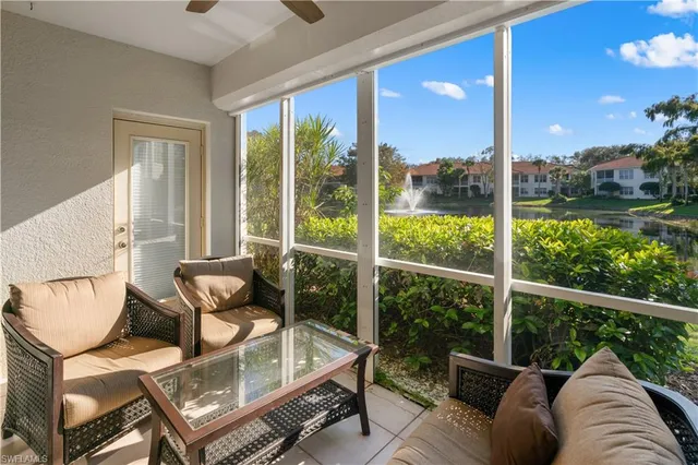 a view of a living room and a floor to ceiling window and wooden floor
