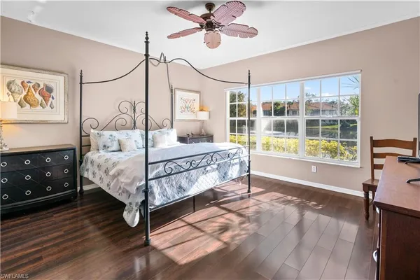 a bedroom with a bed window and table