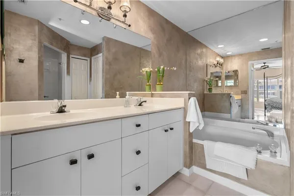 a bathroom with double vanity sink and a mirror