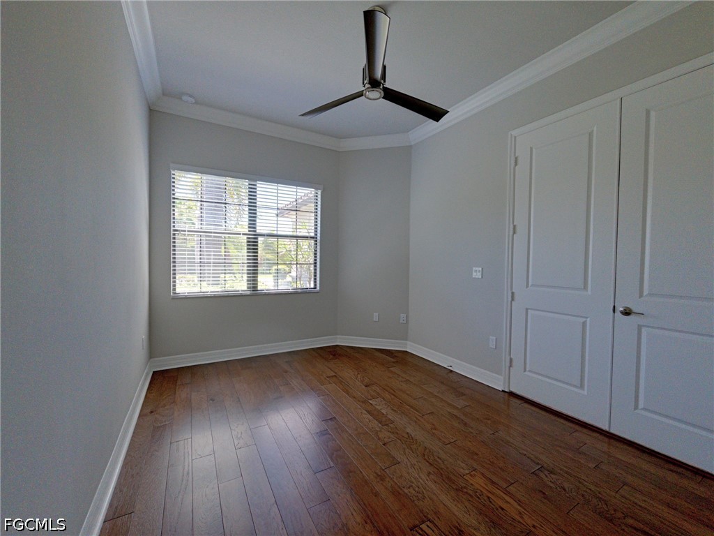 4129 Amelia Way Naples, FL 34119 - Photo 13 of 23 a view of an empty room with wooden floor and a window