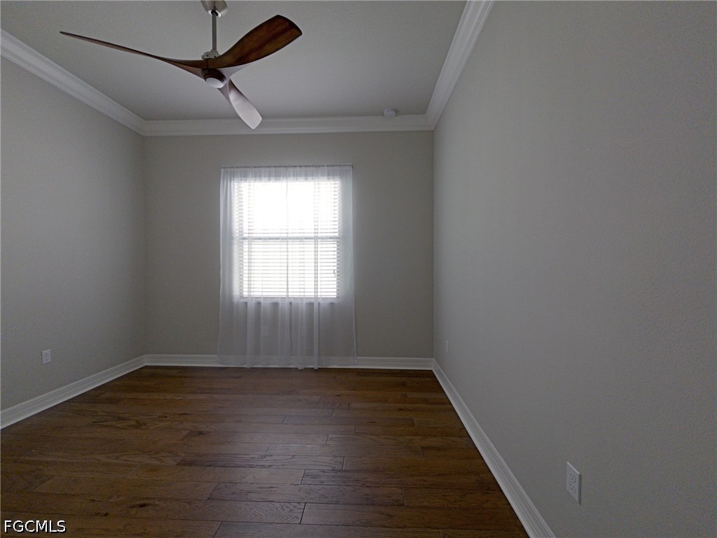 4129 Amelia Way Naples, FL 34119 - Photo 16 of 23 wooden floor in an empty room with a window