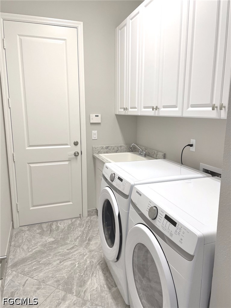 4129 Amelia Way Naples, FL 34119 - Photo 18 of 23 a utility room with dryer and washer