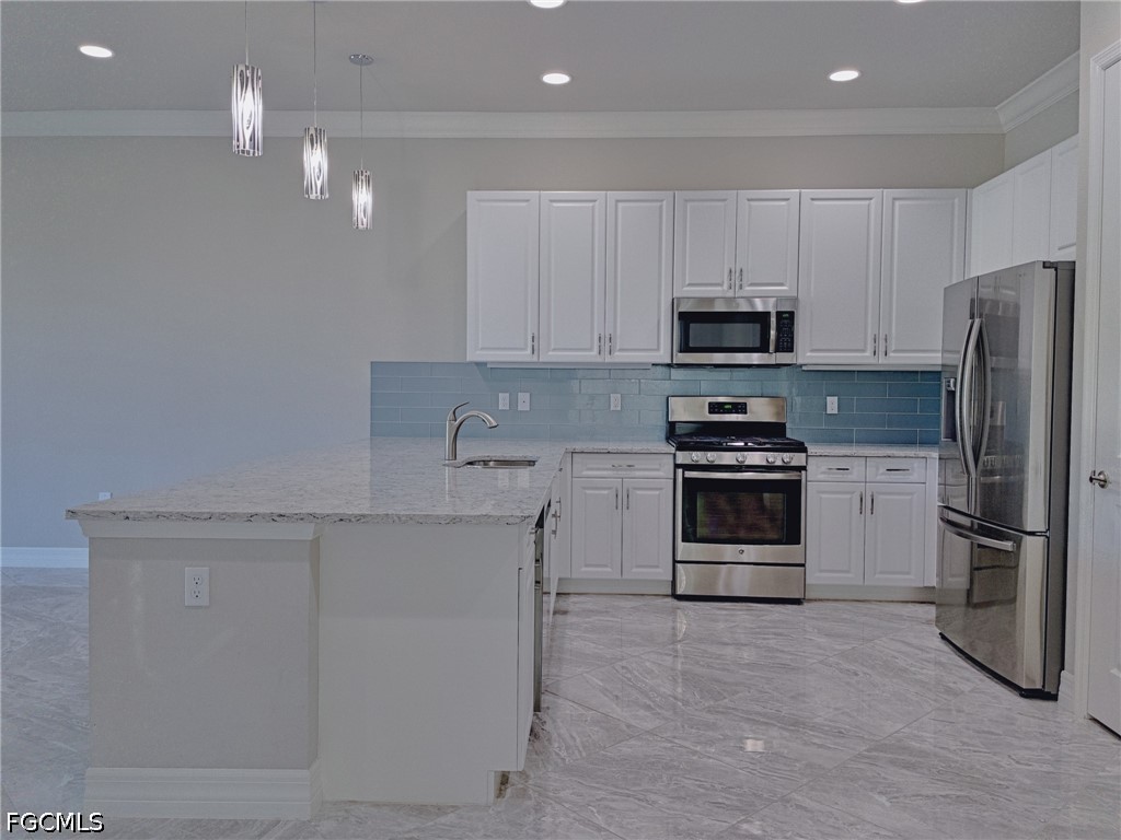 4129 Amelia Way Naples, FL 34119 - Photo 7 of 23 a kitchen with stainless steel appliances a stove a sink and a refrigerator