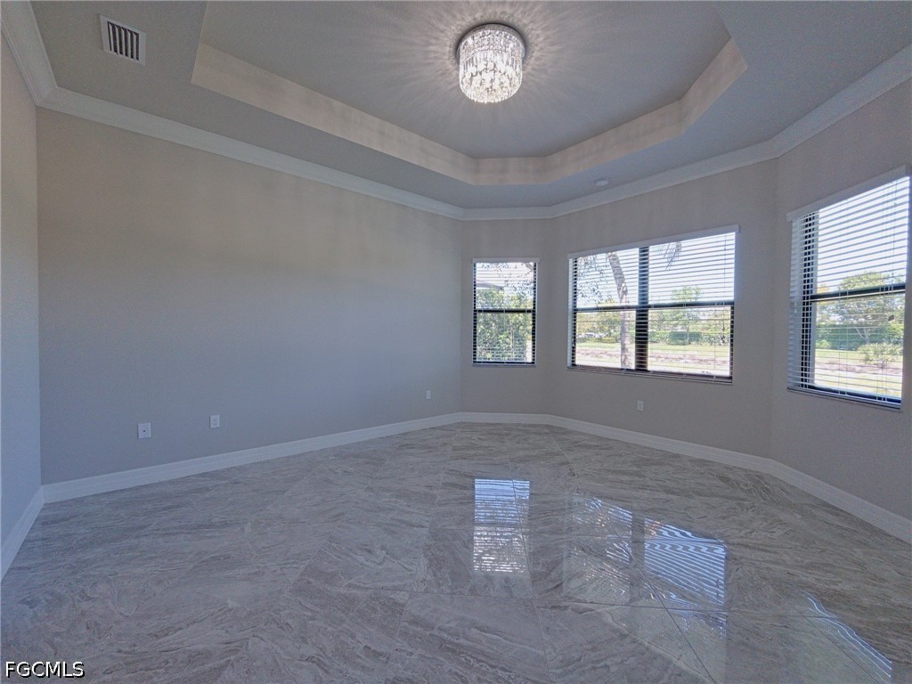 4129 Amelia Way Naples, FL 34119 - Photo 9 of 23 an empty room with windows