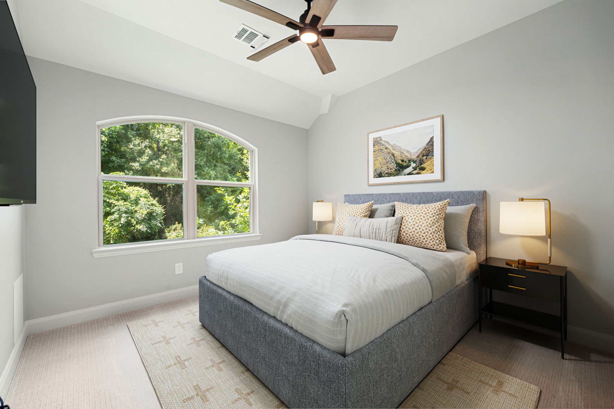 98 Herons Flight Place Spring, TX 77389 - Photo 17 of 29 Comfortable secondary bedroom featuring a vaulted ceiling, oversized arched window, and plush carpet. *Virtually Staged