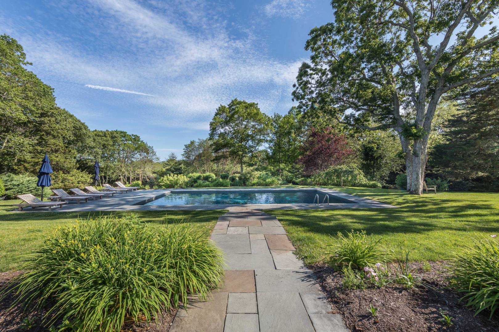 253 Georgica Road East Hampton, NY 11937 - Photo 17 of 19 a view of a swimming pool with a yard