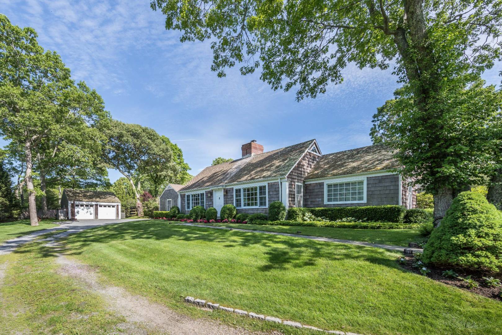 253 Georgica Road East Hampton, NY 11937 - Photo 3 of 19 a front view of a house with a garden