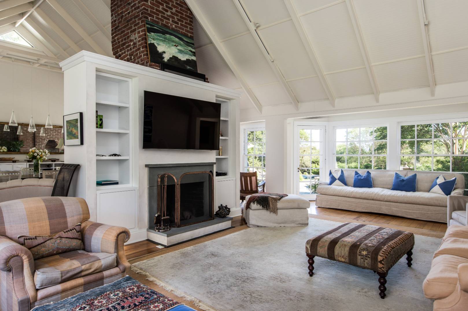 253 Georgica Road East Hampton, NY 11937 - Photo 7 of 19 a living room with furniture a flat screen tv and a fireplace