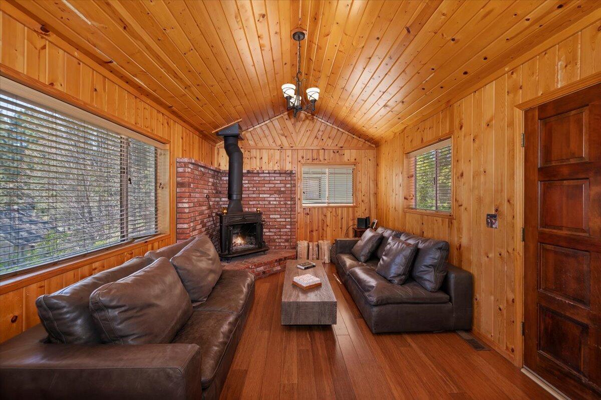 39187 Arapahoe Road Fawnskin, CA 92333 - Photo 8 of 33 a living room with furniture and a chandelier