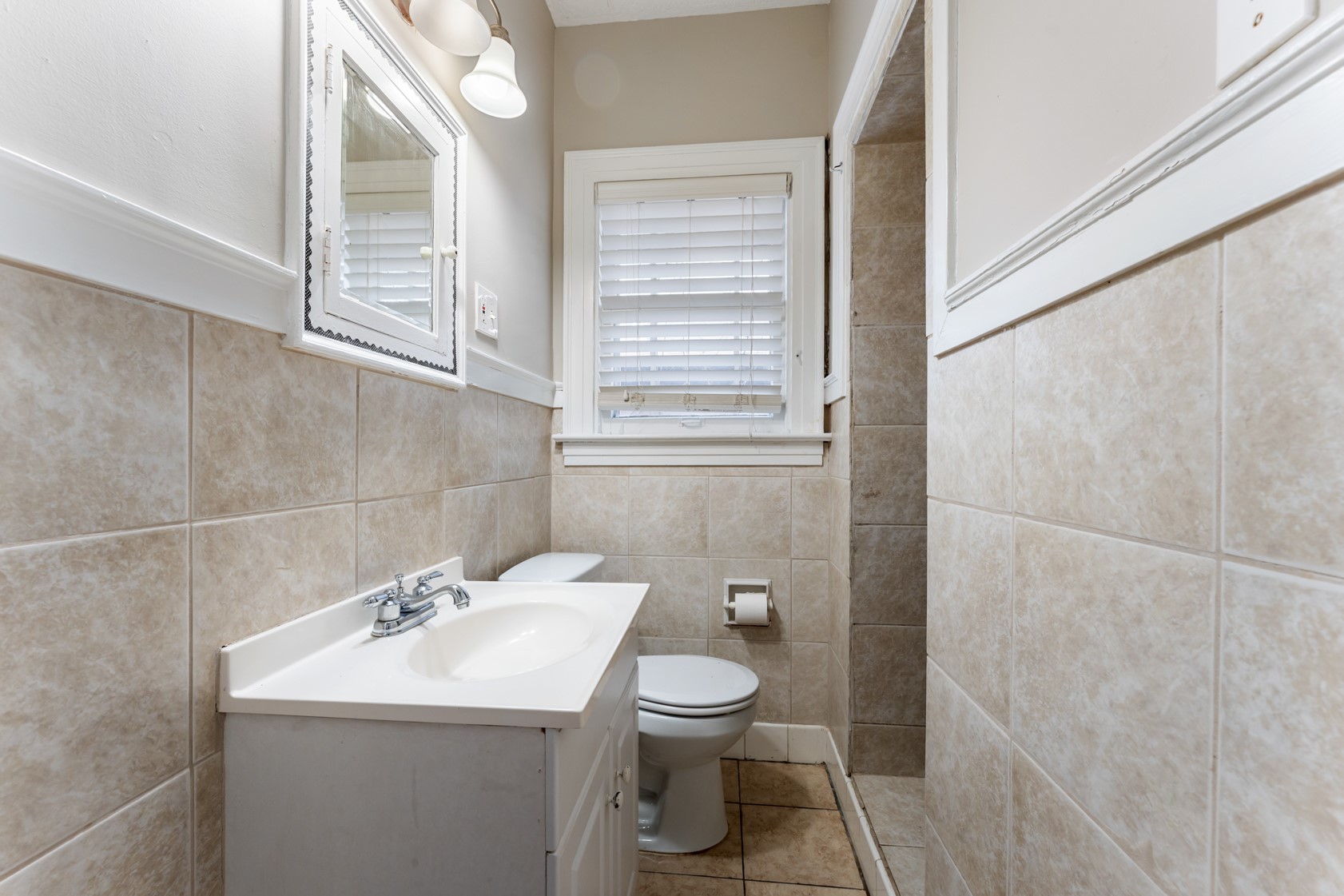 2624 Arbor Street Houston, TX 77004 - Photo 16 of 26 a bathroom with a toilet sink and mirror