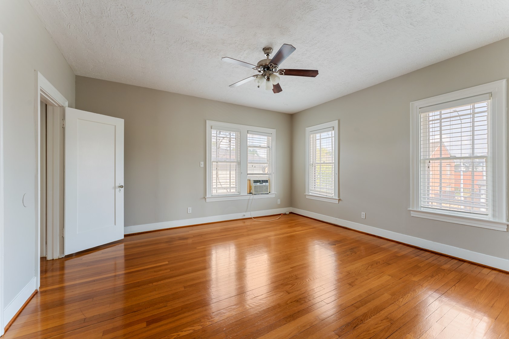 2624 Arbor Street Houston, TX 77004 - Photo 17 of 26 a view of an empty room with wooden floor and a window