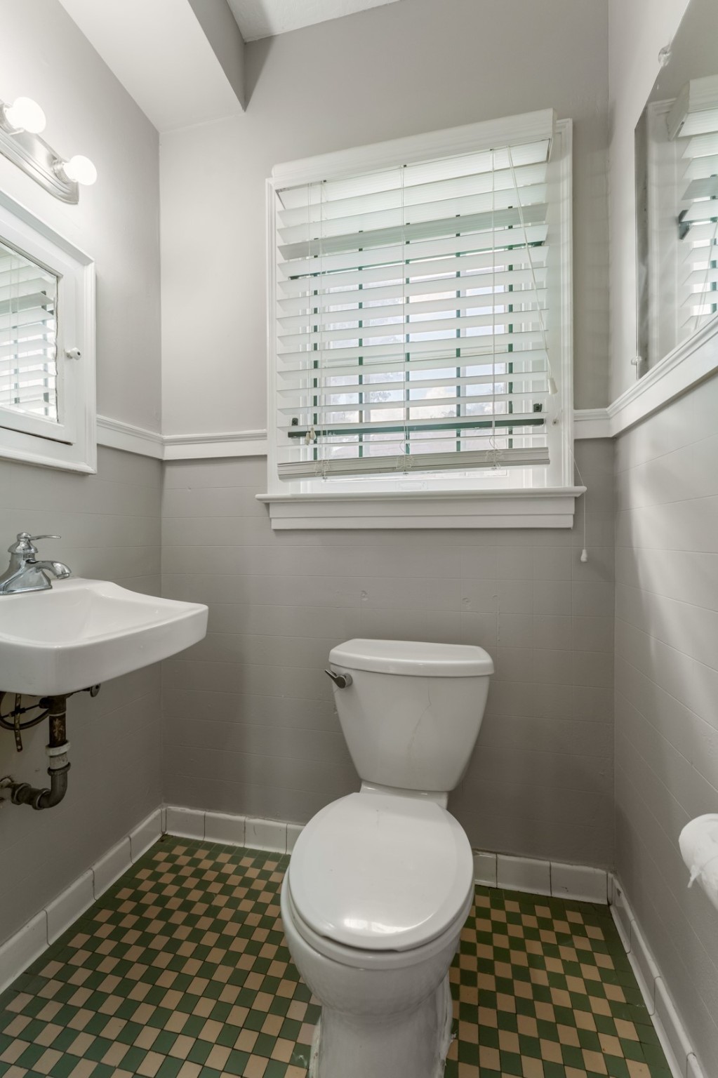 2624 Arbor Street Houston, TX 77004 - Photo 22 of 26 a bathroom with a toilet a sink and a window