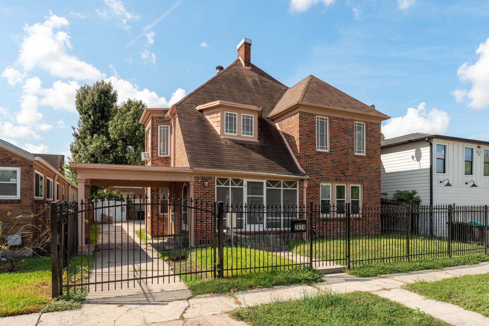 2624 Arbor Street Houston, TX 77004 - Photo 26 of 26 a view of a brick house with large windows and a fence