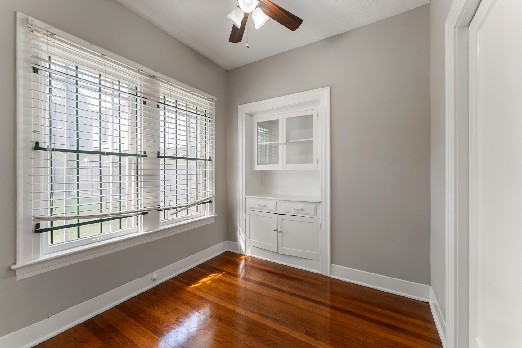 2624 Arbor Street Houston, TX 77004 - Photo 9 of 26 a view of an empty room with a window and wooden floor