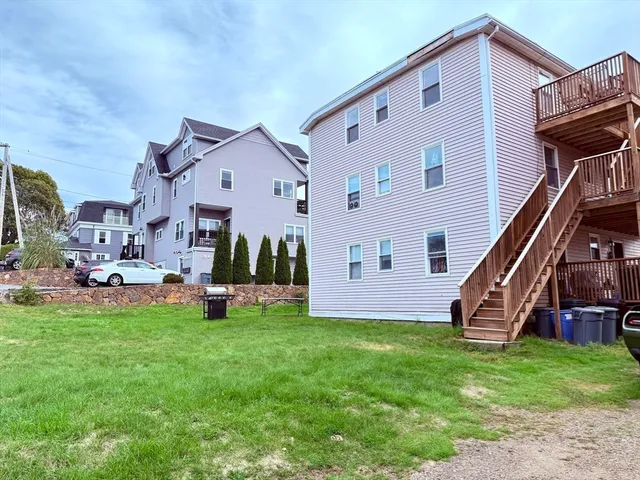 a view of a house with a yard and sitting area