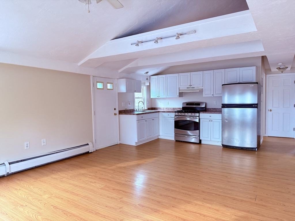 16 Cox Court, Unit 3 Beverly, MA 01915 - Photo 2 of 14 a kitchen with stainless steel appliances a refrigerator and a stove top oven