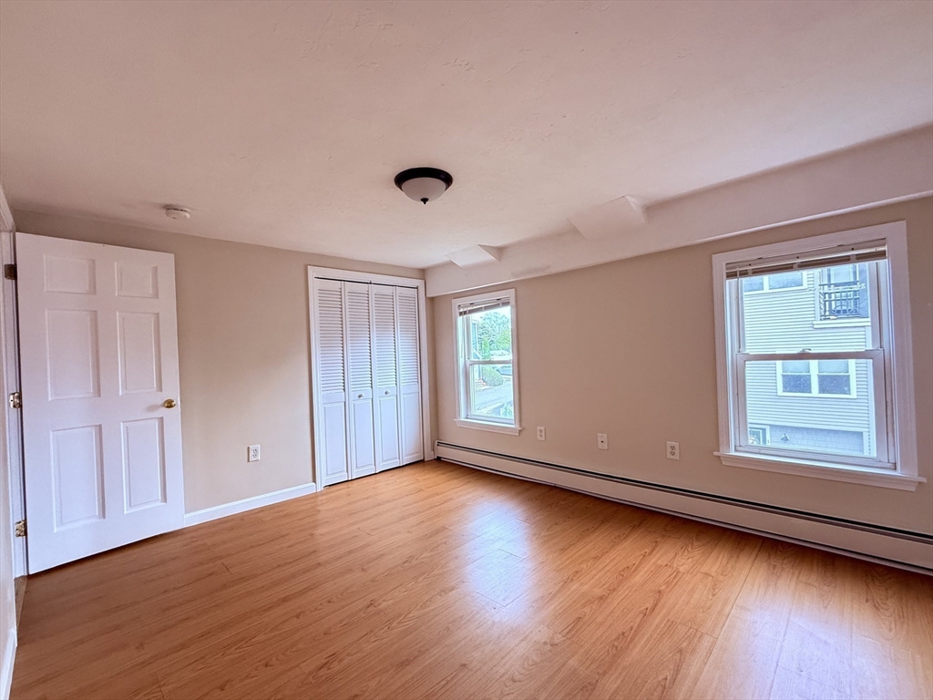 16 Cox Court, Unit 3 Beverly, MA 01915 - Photo 5 of 14 a view of an empty room with wooden floor and a window
