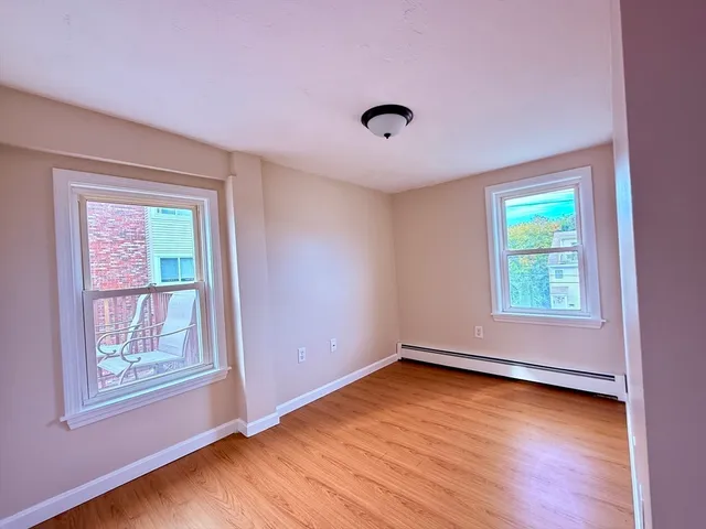 a view of room with window and hardwood floor