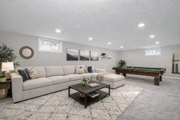 a living room with furniture and a rug