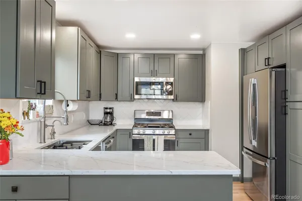a kitchen with a refrigerator and a sink