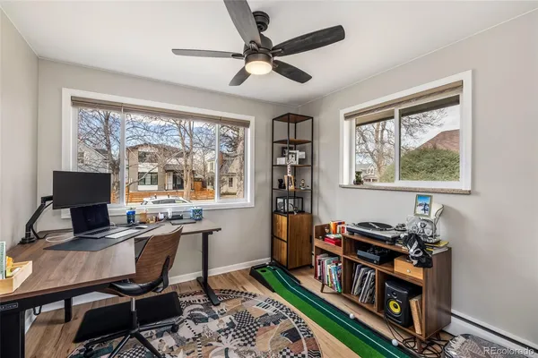 a view of a workspace with furniture and a window
