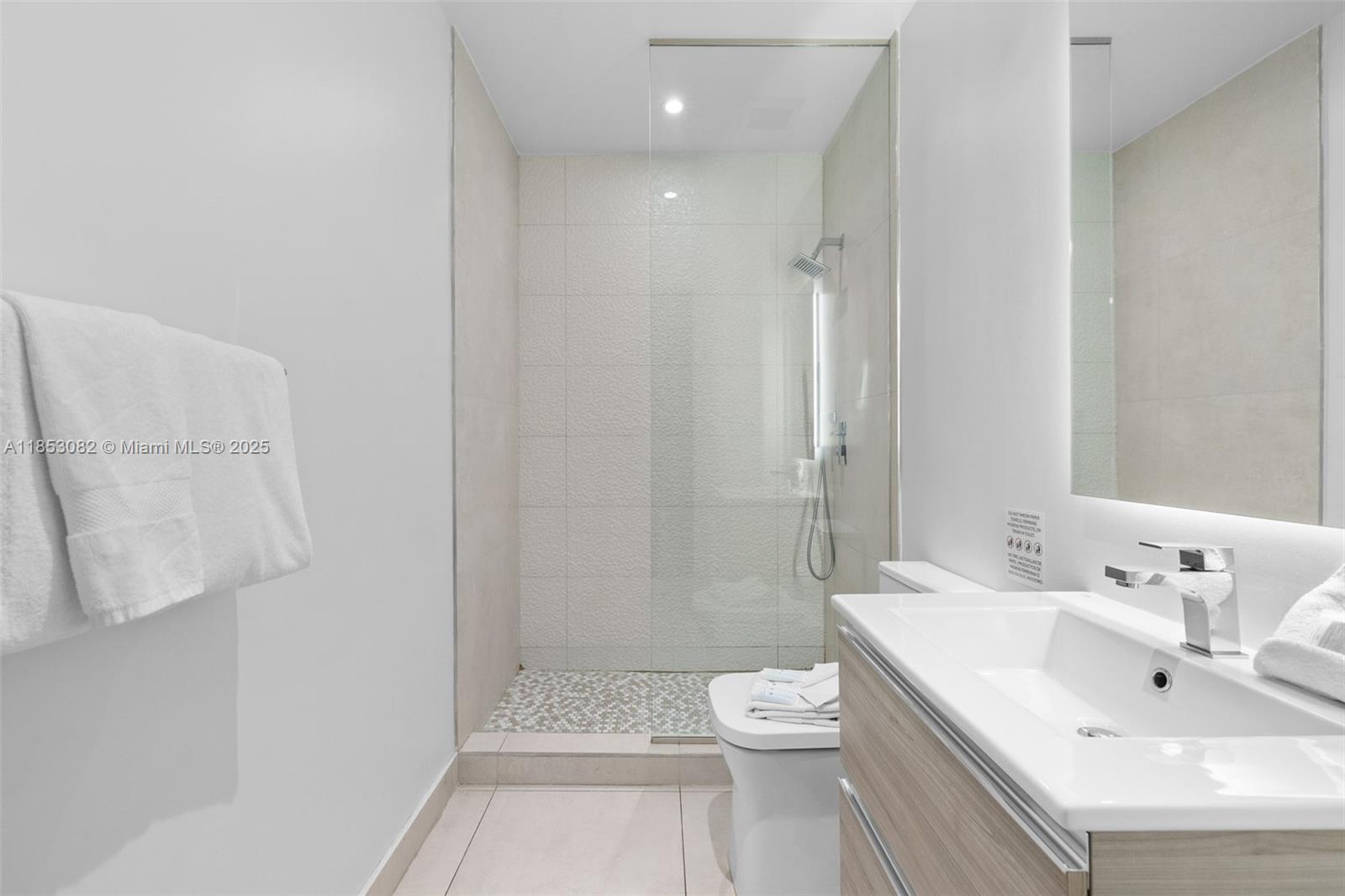 239 Southwest 9th Street, Unit 2303 Miami, FL 33130 - Photo 12 of 75 a bathroom with a sink toilet and shower