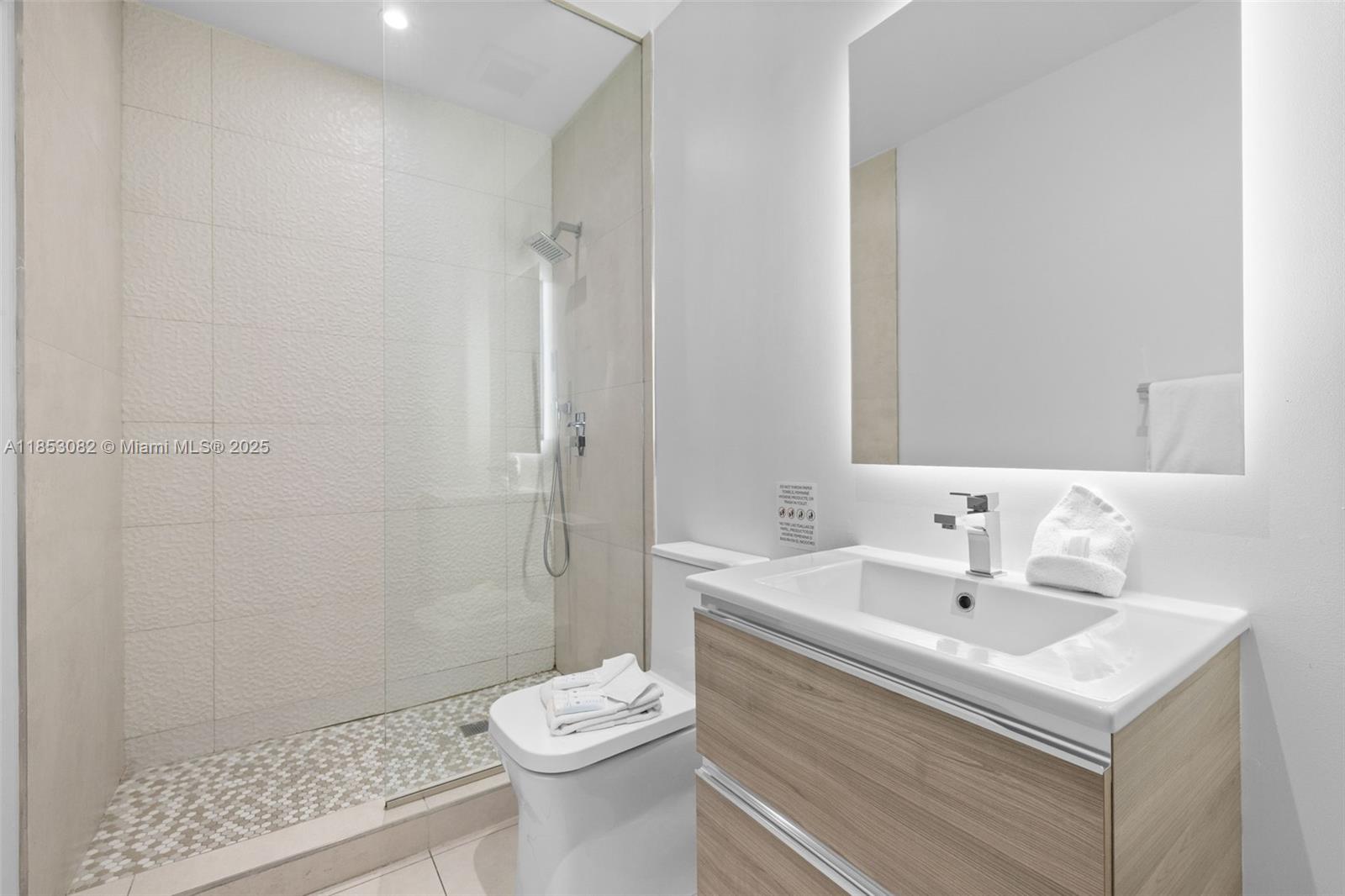 239 Southwest 9th Street, Unit 2303 Miami, FL 33130 - Photo 13 of 75 a bathroom with a sink toilet and shower