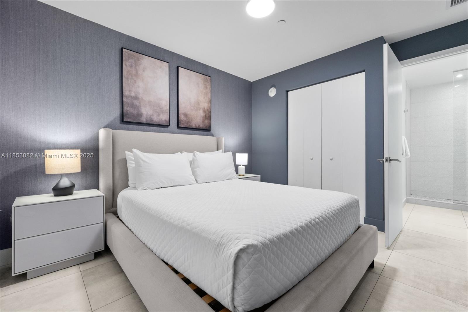 239 Southwest 9th Street, Unit 2303 Miami, FL 33130 - Photo 16 of 75 a bedroom with a bed and a painting