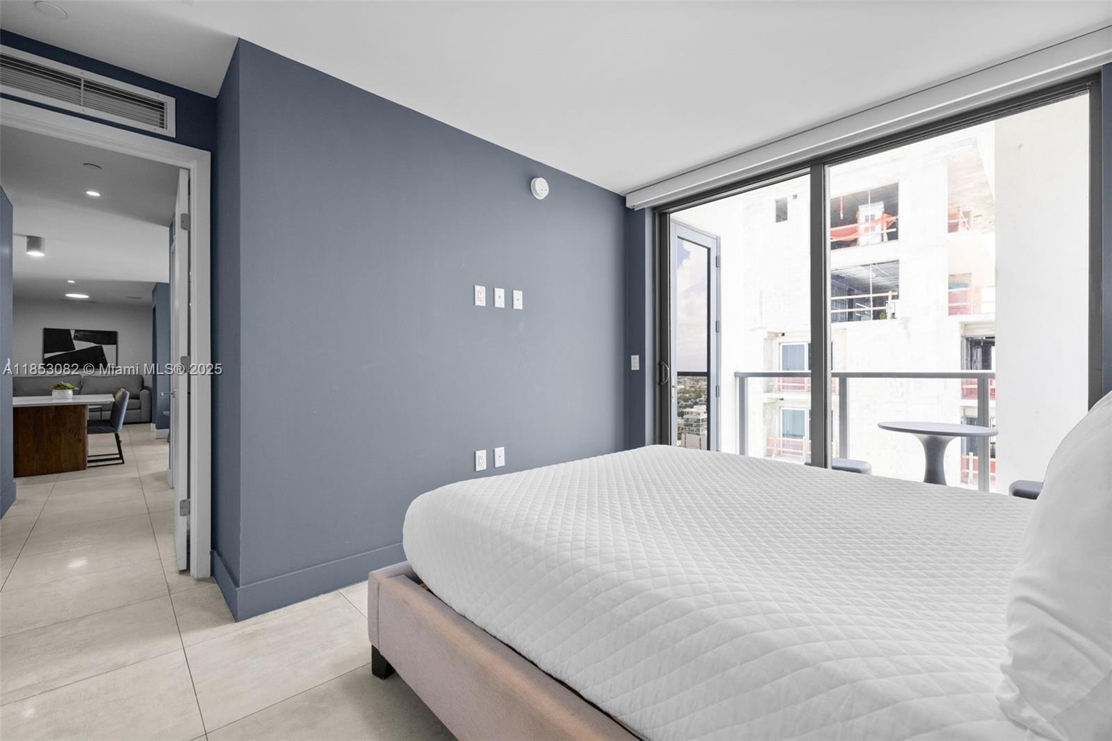 239 Southwest 9th Street, Unit 2303 Miami, FL 33130 - Photo 17 of 75 a bedroom with a large bed and a large window