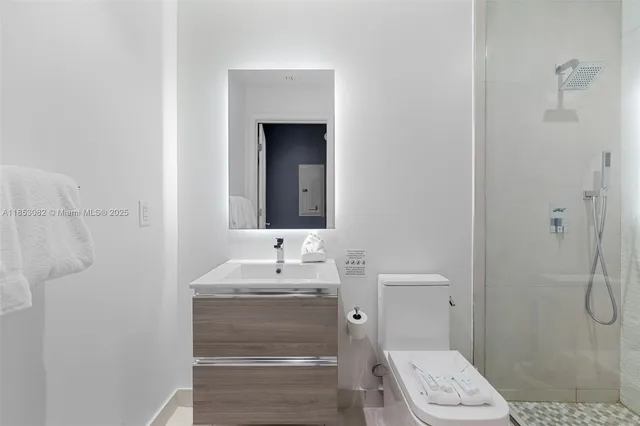 a bedroom with a bed and a refrigerator