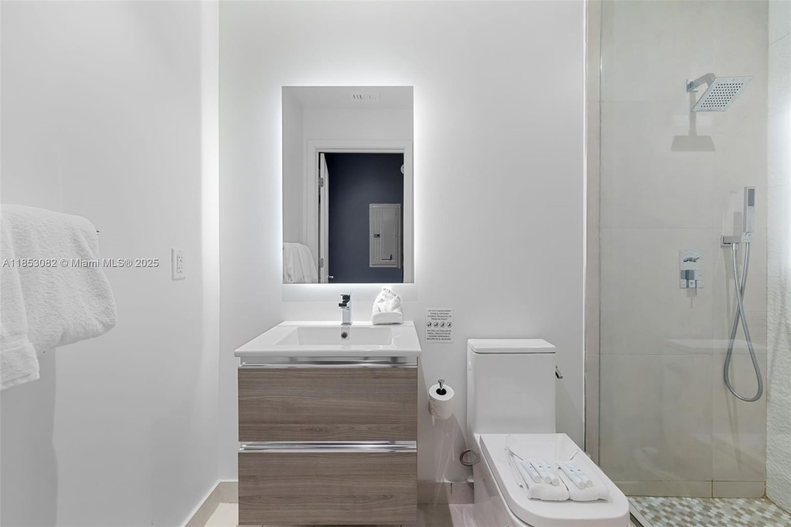 239 Southwest 9th Street, Unit 2303 Miami, FL 33130 - Photo 19 of 75 a bathroom with a sink a toilet and shower