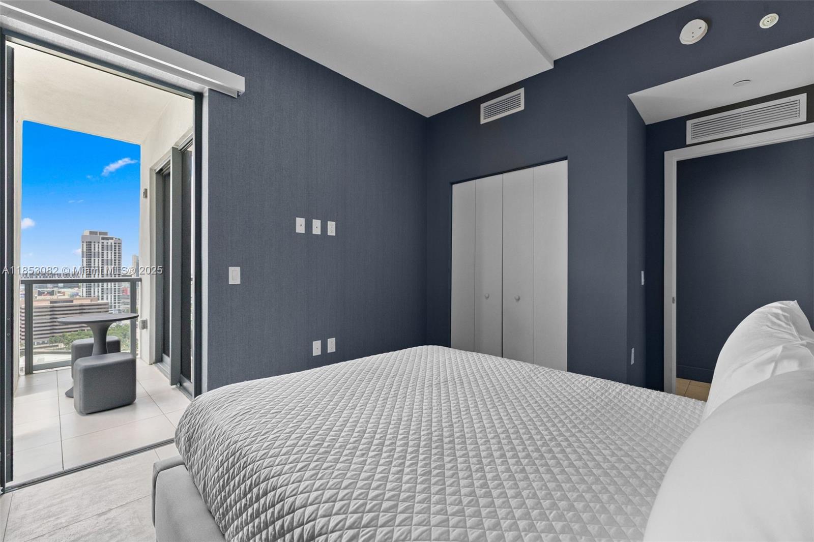 239 Southwest 9th Street, Unit 2303 Miami, FL 33130 - Photo 22 of 75 a bedroom with a bed and glass door