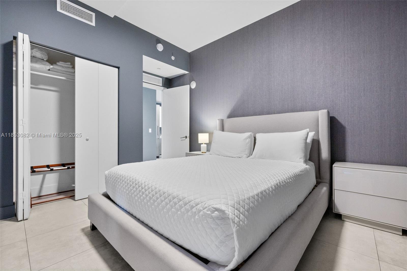 239 Southwest 9th Street, Unit 2303 Miami, FL 33130 - Photo 23 of 75 a bedroom with a bed and a refrigerator